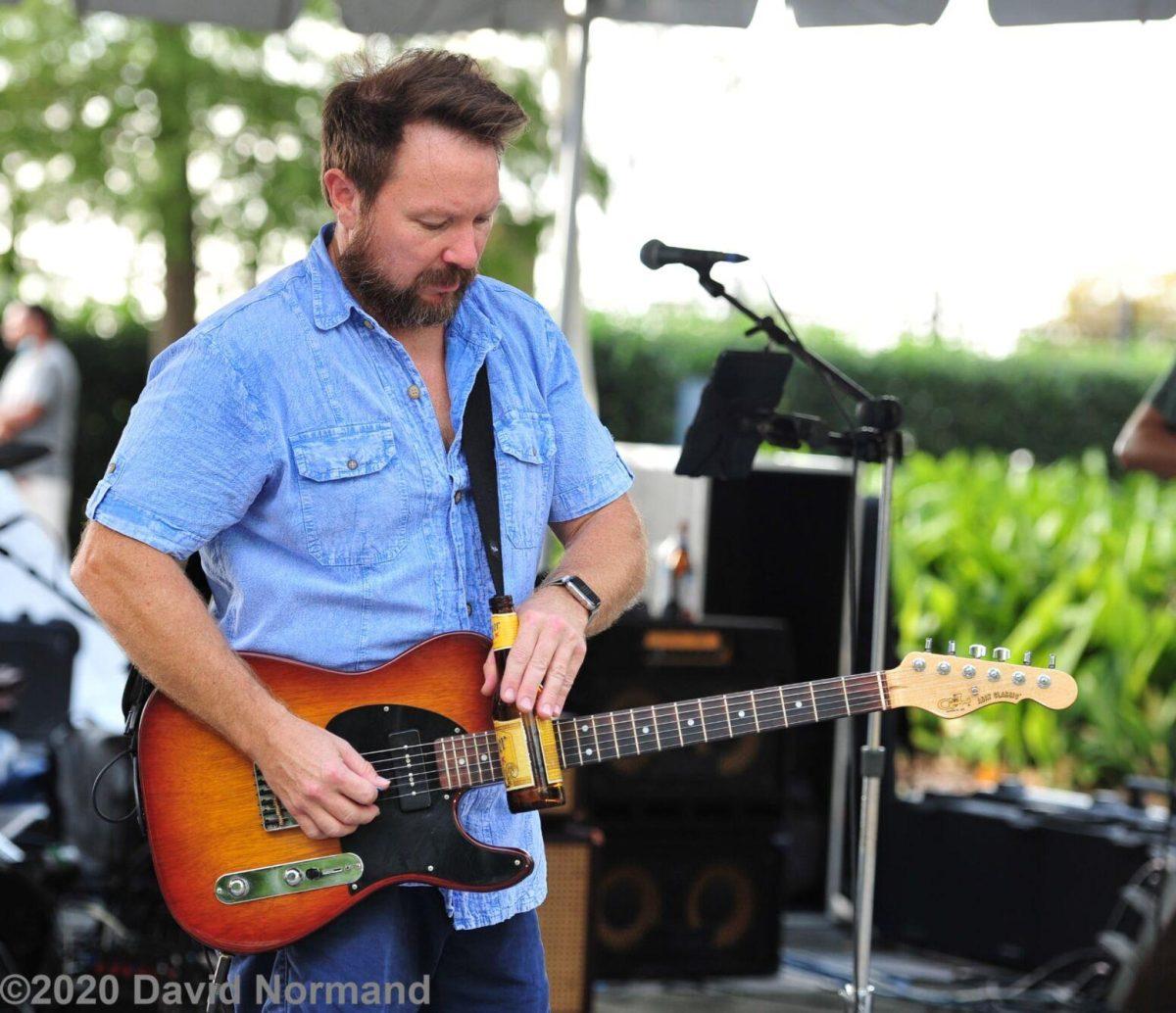 Cam Pyle prepares to play another song on stage.