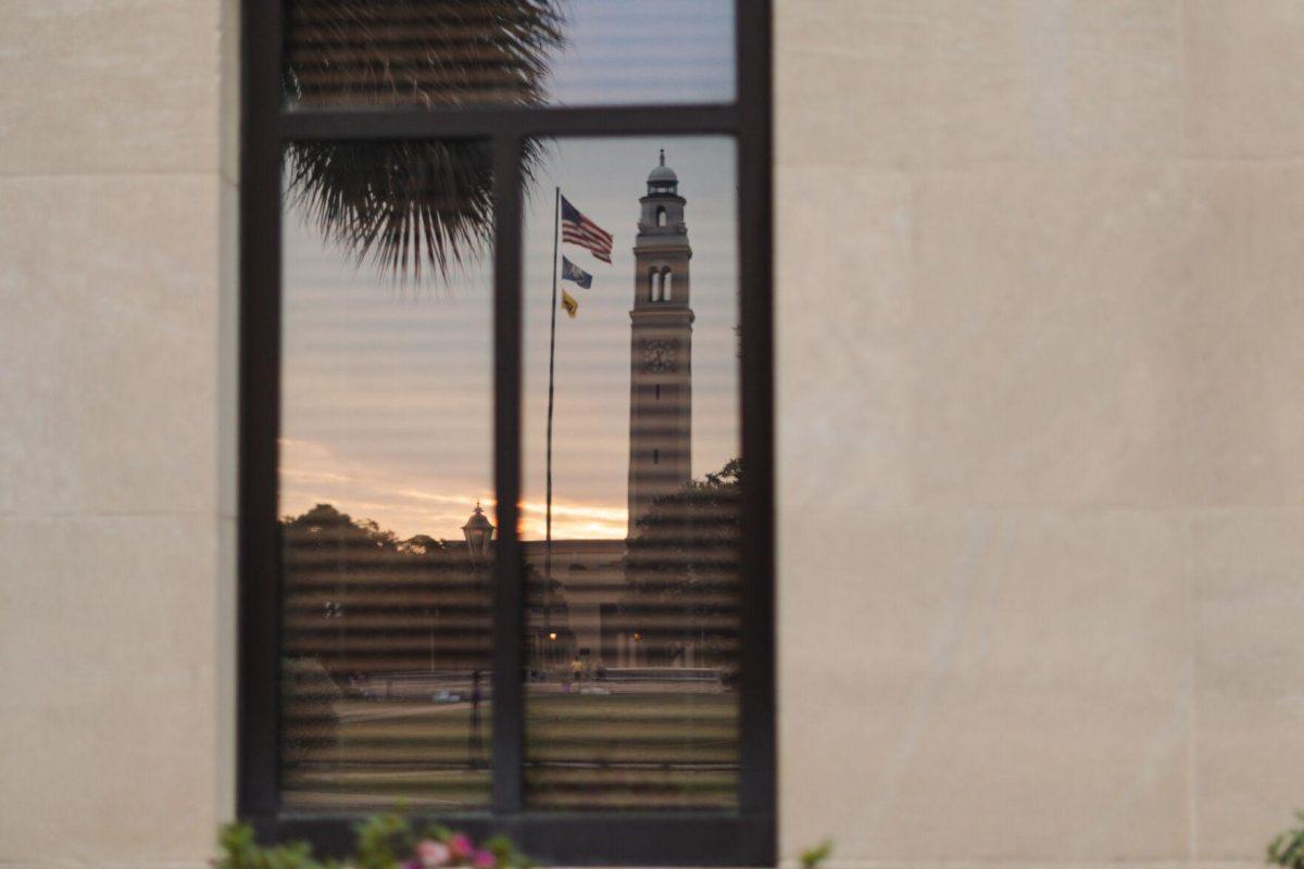 Memorial Tower reflects in a window on Monday, Oct. 17, 2022, at the LSU Law Center on Highland Road in Baton Rouge, La.