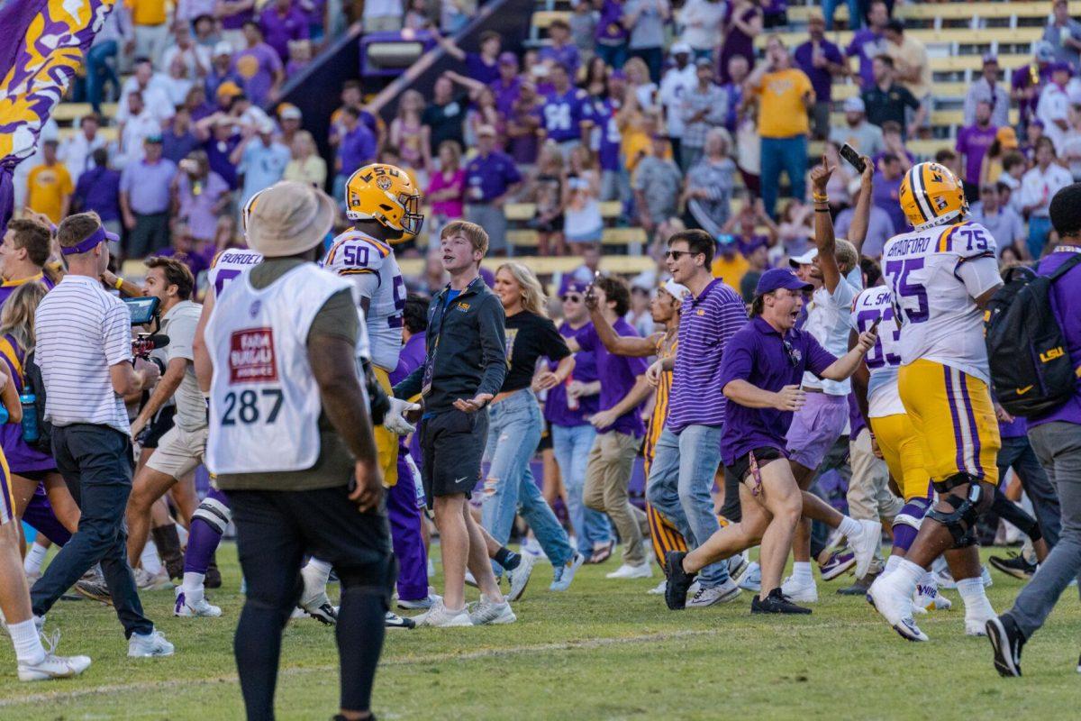 LSU fans run on to the field on Saturday, Oct. 22, 2022, after LSU&#8217;s 45-20 victory over Ole Miss in Tiger Stadium in Baton Rouge, La.