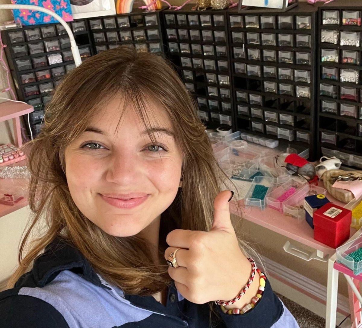 Mackenzie Paradis poses at her jewelry work station.