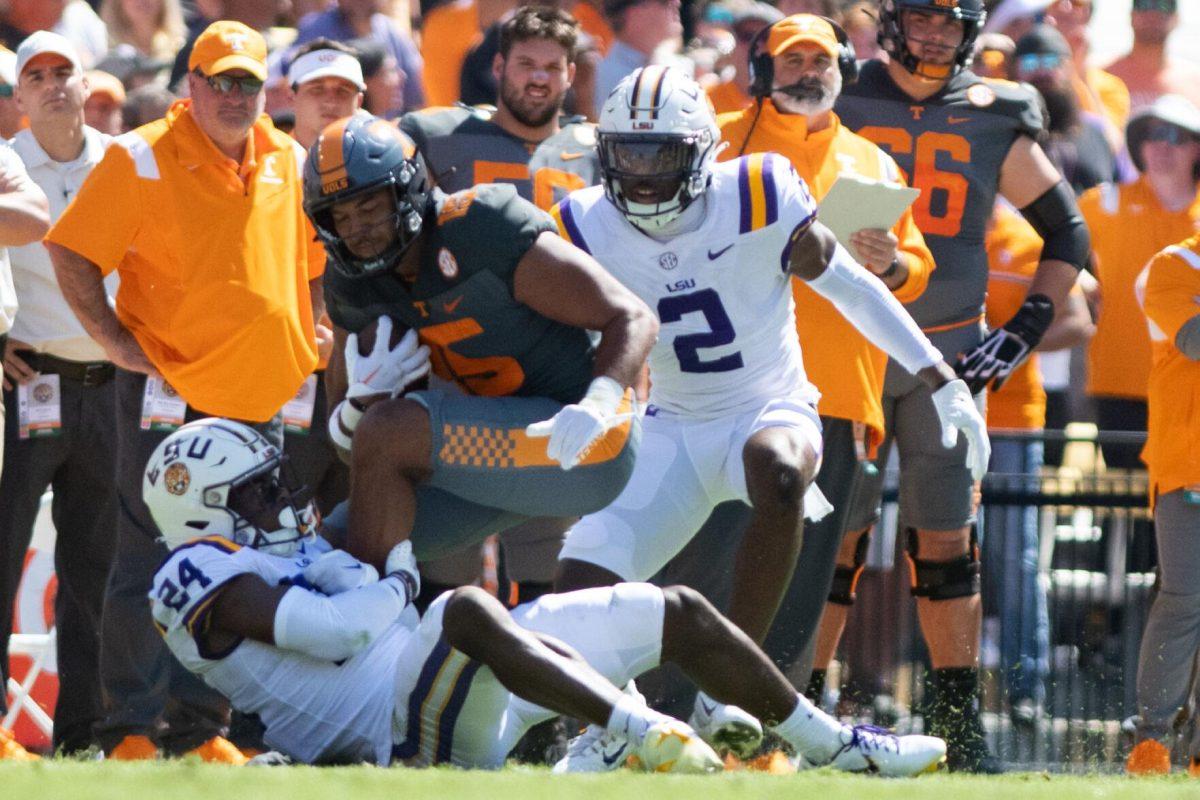 LSU senior cornerback Jarrick Bernard-Converse (24) attempts to tackle Tennessee wide receiver Bru McCoy (15) on Saturday, Oct. 8, 2022, during LSU's defeat to Tennessee 13-40 in Tiger Stadium.