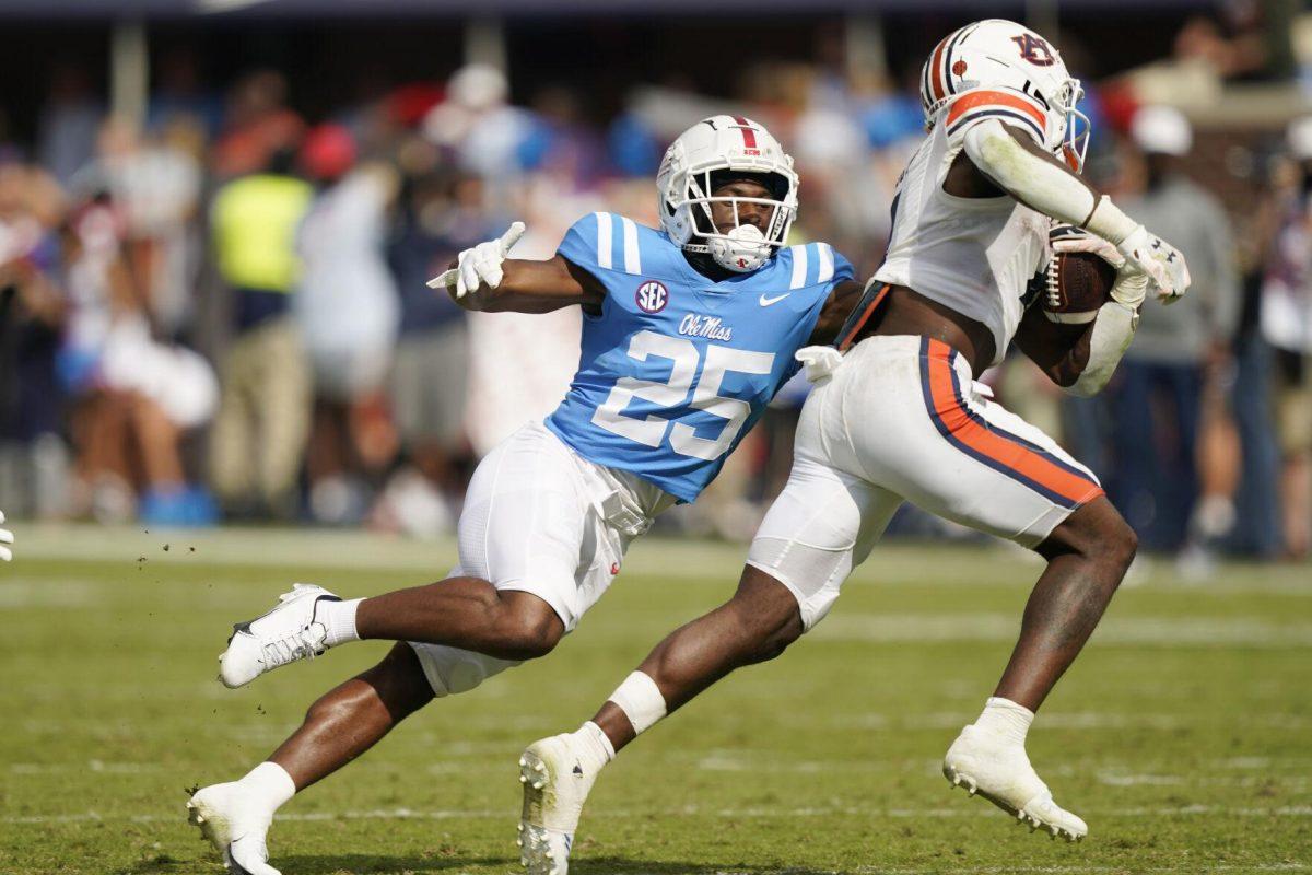 Mississippi safety Trey Washington (25) pressures Auburn running back Tank Bigsby (4) during the second half of an NCAA college football game in Oxford, Miss., Saturday, Oct. 15, 2022. Mississippi won 48-34. (AP Photo/Rogelio V. Solis)