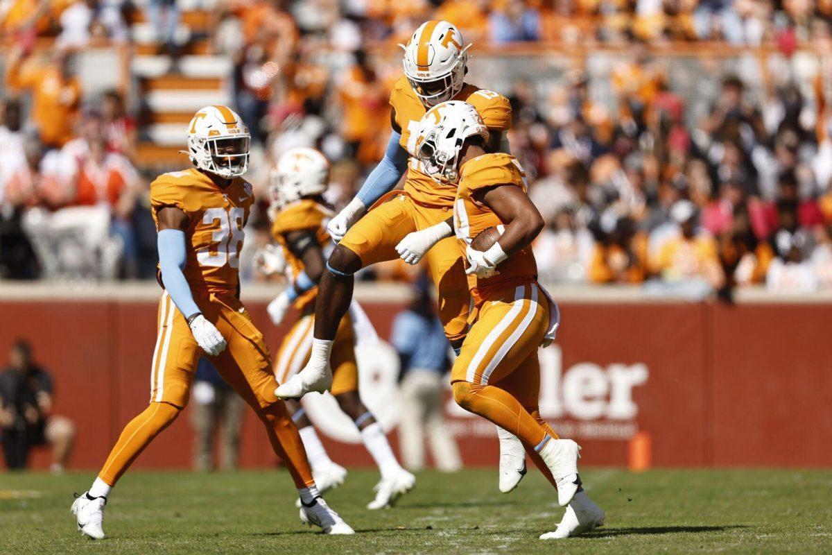 Tennessee linebacker Aaron Beasley (24) celebrates a fumble recovery with defensive lineman Joshua Josephs (19), and linebacker Solon Page III (38) during the first half of an NCAA college football game against the Tennessee Martin, Saturday, Oct. 22, 2022, in Knoxville, Tenn. (AP Photo/Wade Payne)