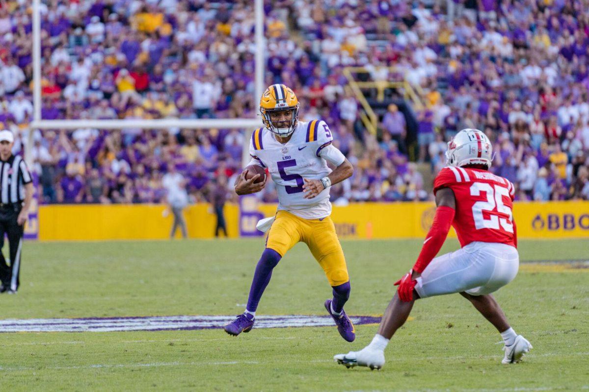 LSU football junior quarterback Jayden Daniels (5) tries to evade the opponent on Saturday, Oct. 22, 2022, during LSU&#8217;s 45-20 victory over Ole Miss in Tiger Stadium in Baton Rouge, La.