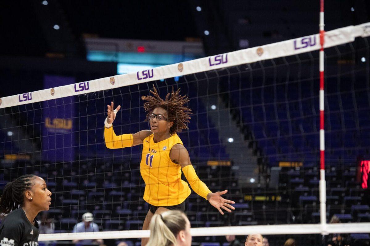 LSU volleyball senior middle blocker Anita Anwusi (11) comes down after jumping for the ball on Sunday, Oct. 30, 2022, during LSU&#8217;s 3-2 loss to Mississippi State at the Pete Maravich Assembly Center in Baton Rouge, La.