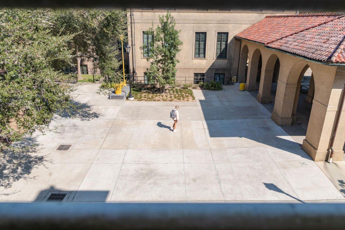 An LSU student looks at their phone on Friday, Oct. 7, 2022, as they approach the LSU Quad in Baton Rouge, La.