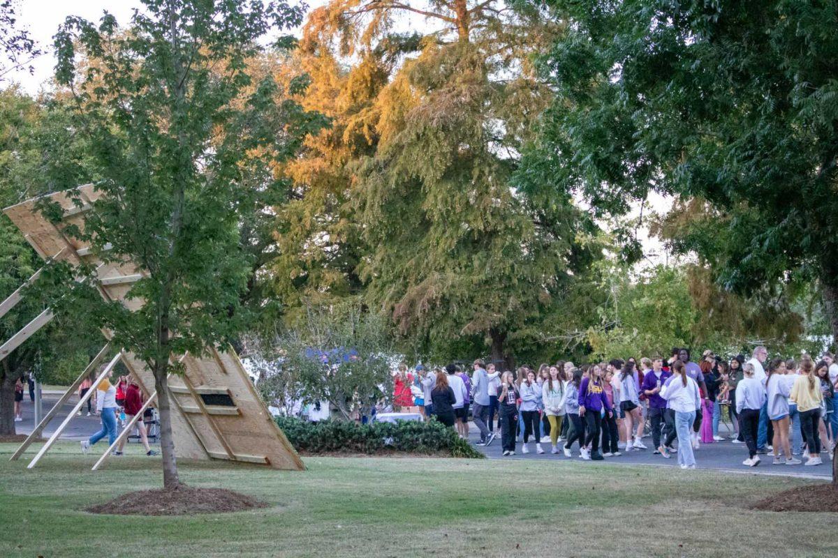 Block party attendees walk along Sorority Row and look at pomping boards on Thursday, Oct. 20, 2022, on West Lakeshore Drive on LSU's campus.