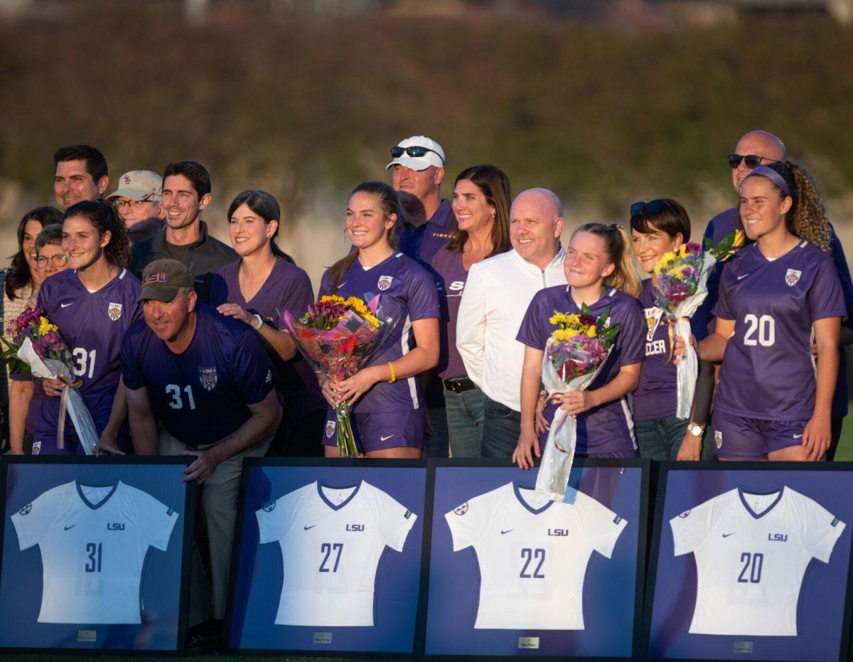 LSU soccer seniors Meghan Johnson (31), Britney Bertram (27), Tilly Wilkes (22), and Brenna McPartlan (20) smile with their families on senior night on Thursday, Oct. 27, 2022, before the start of LSU&#8217;s 4-1 victory against Ole Miss at LSU&#8217;s Soccer Stadium off of Nicholson Drive.