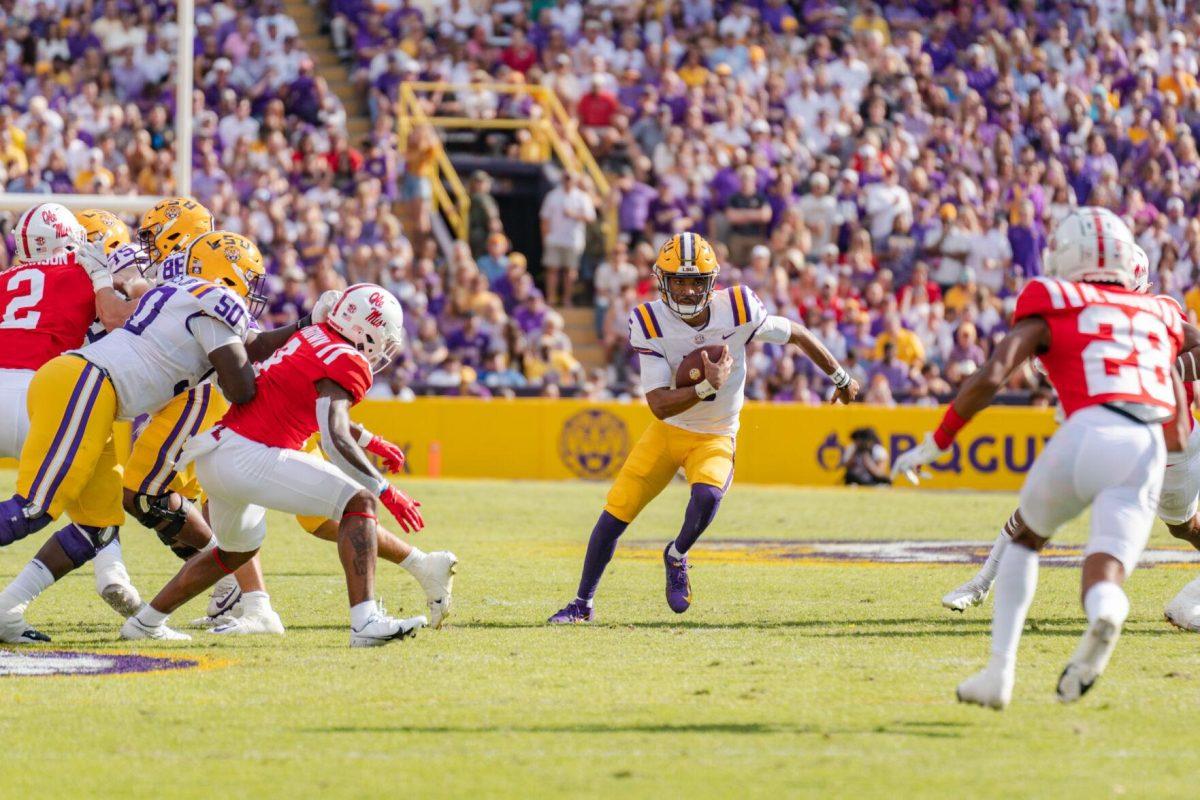 LSU football junior quarterback Jayden Daniels (5) runs with the ball on Saturday, Oct. 22, 2022, during LSU&#8217;s 45-20 victory over Ole Miss in Tiger Stadium in Baton Rouge, La.