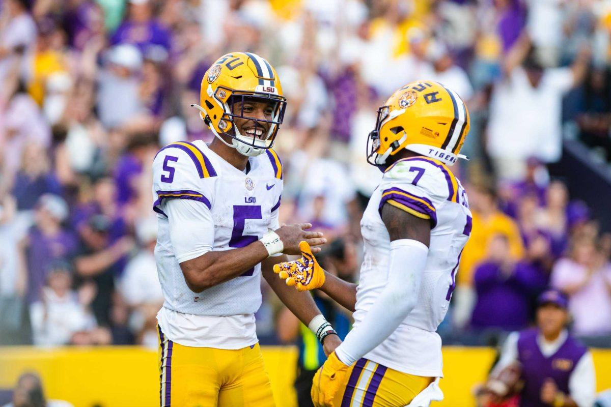 LSU football junior quarterback Jayden Daniels (5) and junior wide receiver Kayshon Boutte (7) dap each other after a touchdown Saturday, Oct. 22, 2022, during LSU&#8217;s 45-20 win against Ole Miss at Tiger Stadium in Baton Rouge, La.