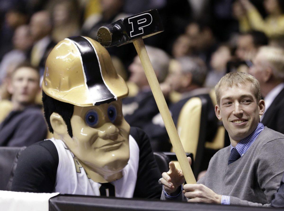 Former Purdue basketball player Robbie Hummel jokes with mascot Purdue Pete before he was honored at halftime of an NCAA college basketball game between Purdue and Michigan State in West Lafayette, Ind., Saturday, Feb. 9, 2013. Hummel is the 14th Purdue player to be honored with a banner in Mackey Arena. Hummel currently plays with Obradoiro CAB in Liga ACB in Spain.(AP Photo/Michael Conroy)