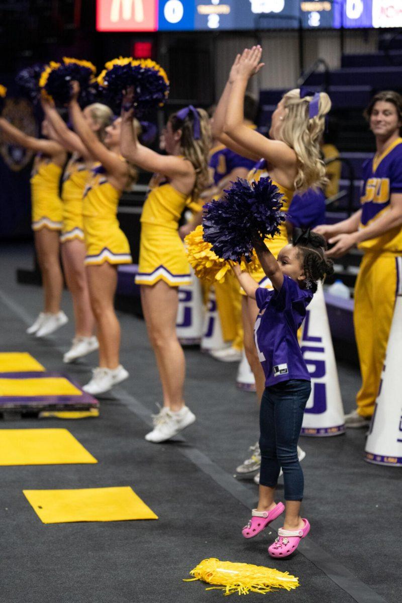 A young LSU volleyball fan dances with the cheerleaders on Saturday, Oct. 1, 2022, during LSU&#8217;s 2-3 defeat to Ole Miss at the Pete Maravich Assembly Center in Baton Rouge, La.