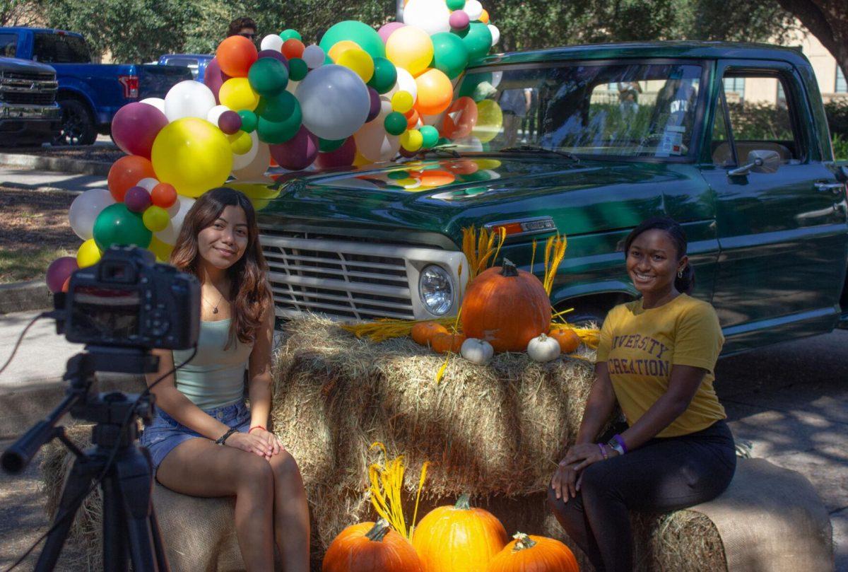 Two LSU students pose in front of a truck on Wednesday, Oct. 5, 2022, on Tower Drive in Baton Rouge, La.