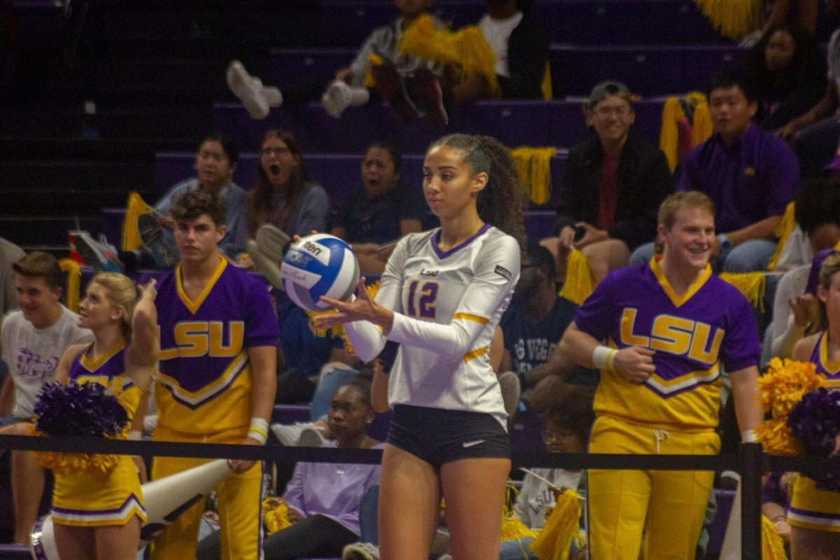 LSU volleyball junior middle blocker Alia Williams (12) focuses on serving the ball on Friday, Sept. 30, 2022, during their 3-2 victory against Ole Miss at the Pete Maravich Assembly Center in Baton Rouge, La.