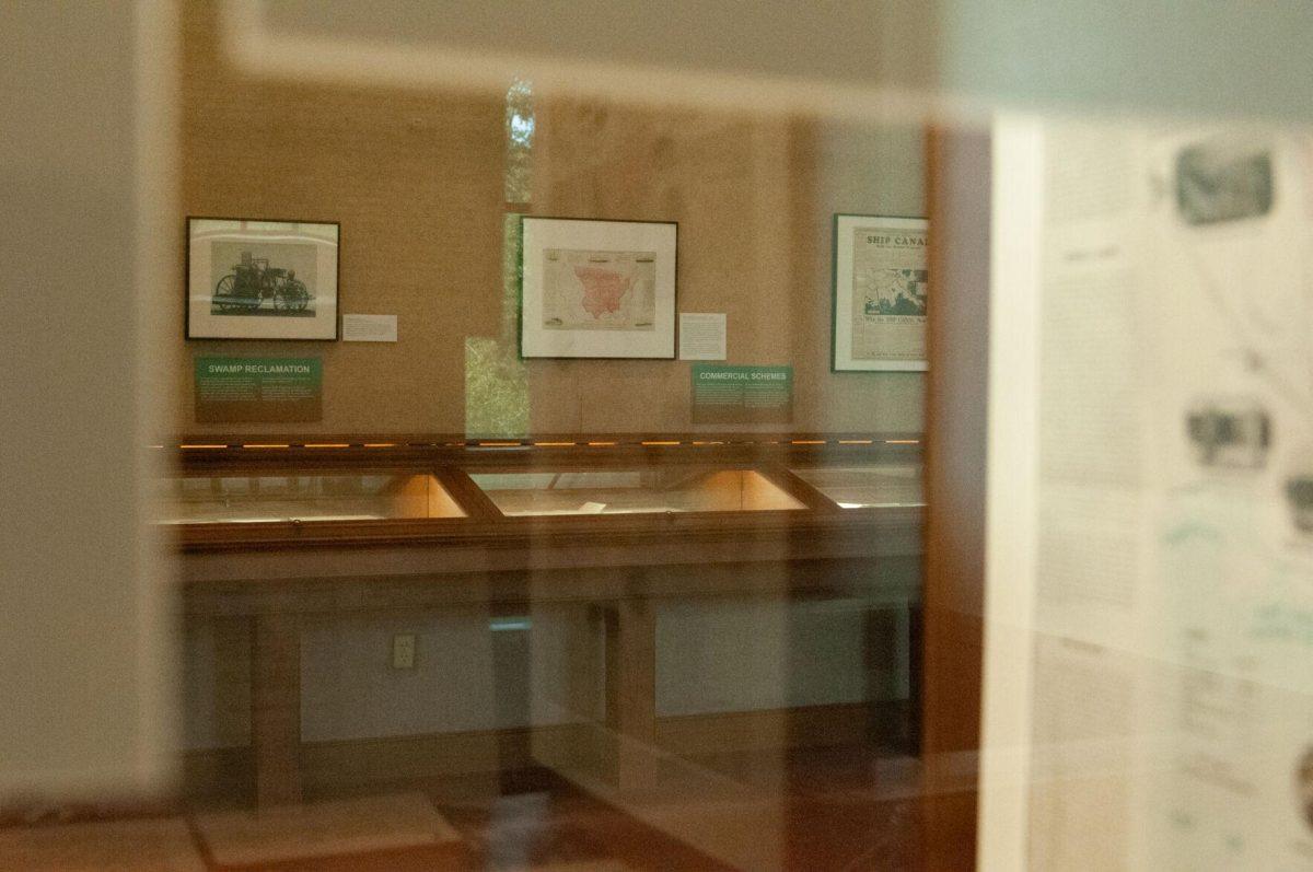 Historical documents are reflected on the display case on the second floor of Hill Memorial Library on Field House Drive in Baton Rouge, La on Tuesday, Oct. 11, 2022 as part of the Water and Louisiana Consequences with Coastal Land exhibit.