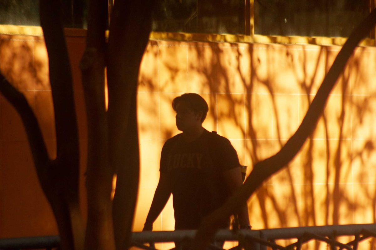 A student walks by the orange wall on Monday, Sept. 26, 2022, along the LSU Library in Baton Rouge, La.