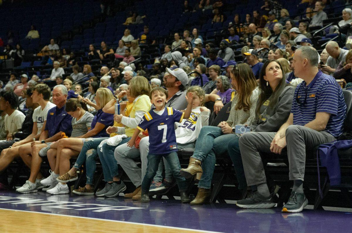 A young fan sitting court-side dances to music during a time out at the LSU women's basketball exhibition game against Mississippi College on Thursday, Oct. 27, 2022, in the Pete Maravich Assembly Center on N. Stadium Drive.