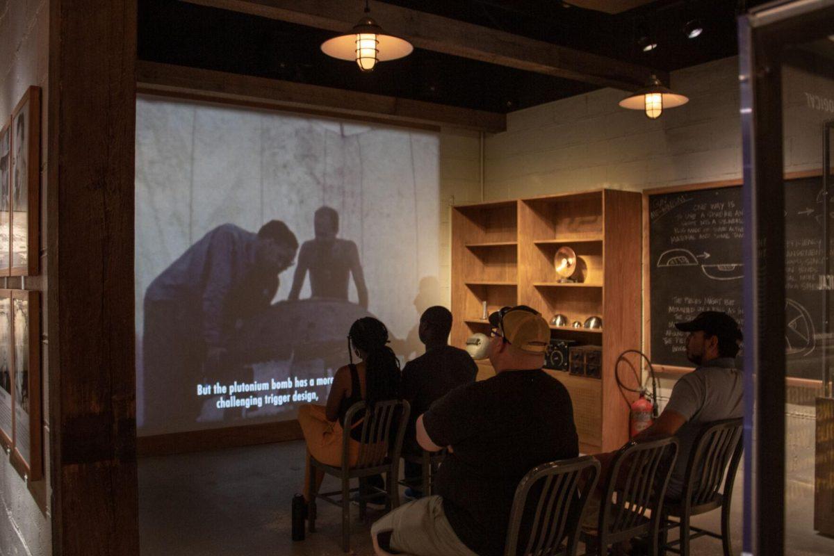 Museum guests watch a program on Saturday, Oct. 1, 2022, at the National World War II Museum in New Orleans, La.