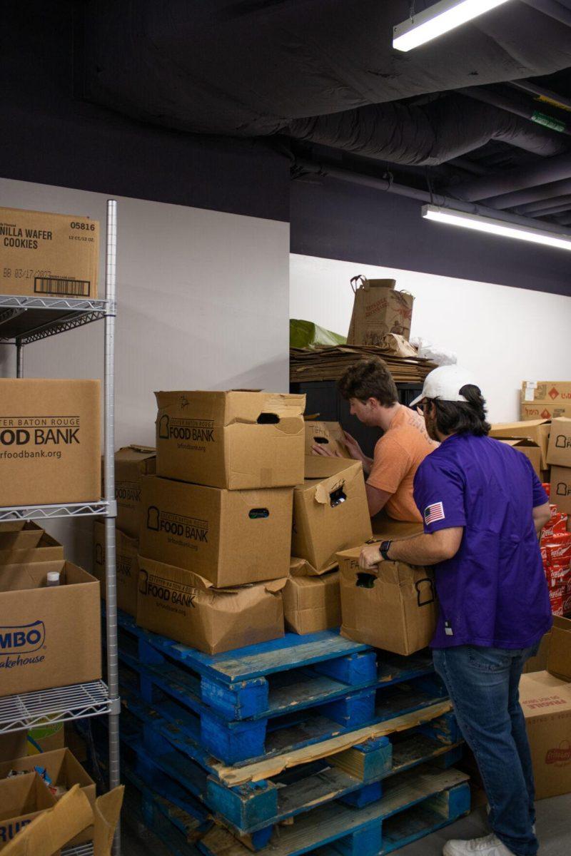 LSU sport management graduate student Bryce Duhon and petroleum engineering sophomore Cayden Boyt stack boxes on Thursday, Oct. 6, 2022, inside the food pantry at the LSU Student Union in Baton Rouge, La.