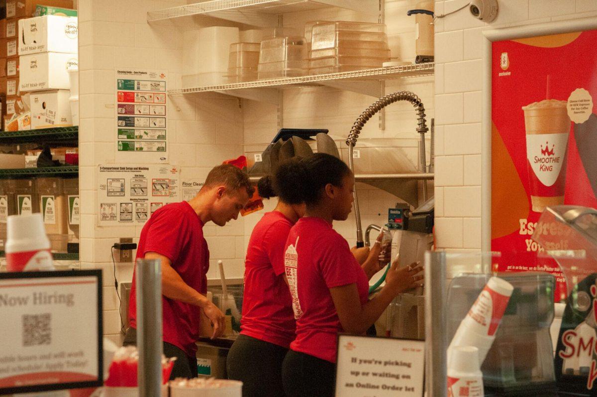 Three Smoothie King employees wash dishes on Thursday, Oct. 6, 2022, in the LSU Student Union on Highland Road in Baton Rouge, La.