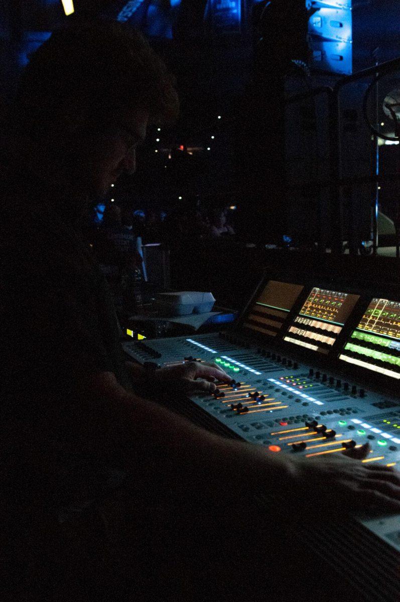 LSU electrical engineering major Arnold Christiansen adjusts sound equipment on Wednesday, Oct. 19, 2022, at LSU's homecoming concert at the PMAC on North Stadium Drive in Baton Rouge, La.