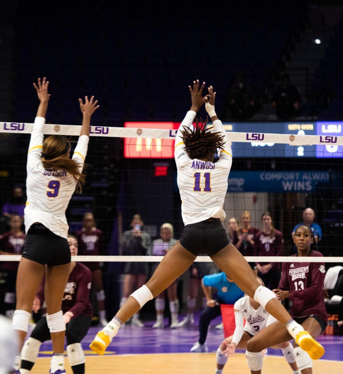 LSU volleyball senior middle blocker Anita Anwusi (11) jumps up to block the ball on Saturday, Oct. 29, 2022, during LSU&#8217;s 3-2 victory against Mississippi State at the Pete Maravich Assembly Center in Baton Rouge, La.