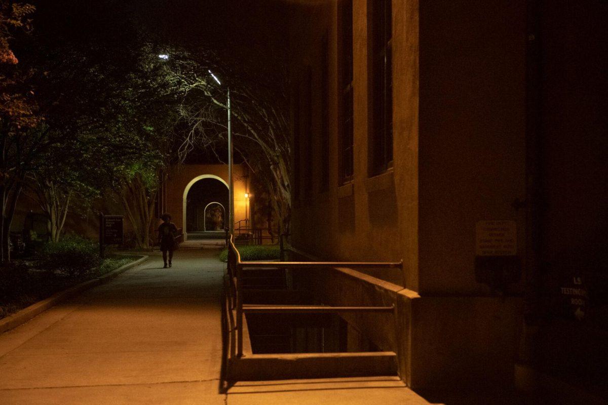 An LSU student walks through the darkness on Wednesday, Oct. 5, 2022, near the Quad in Baton Rouge, La.