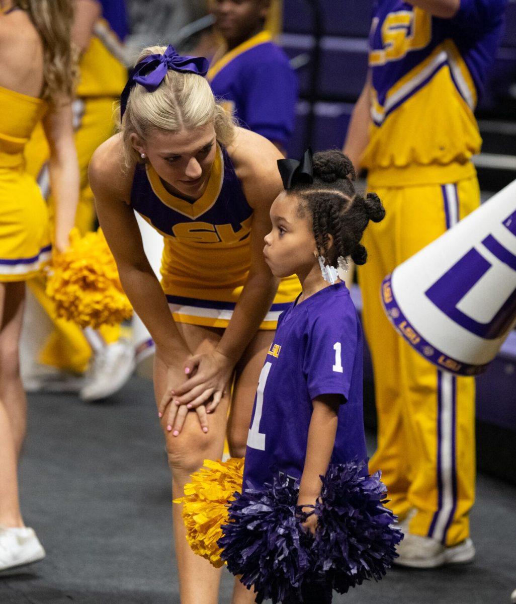 A young LSU volleyball fan stands with the cheerleaders on Saturday, Oct. 1, 2022, during LSU&#8217;s 2-3 defeat to Ole Miss at the Pete Maravich Assembly Center in Baton Rouge, La.