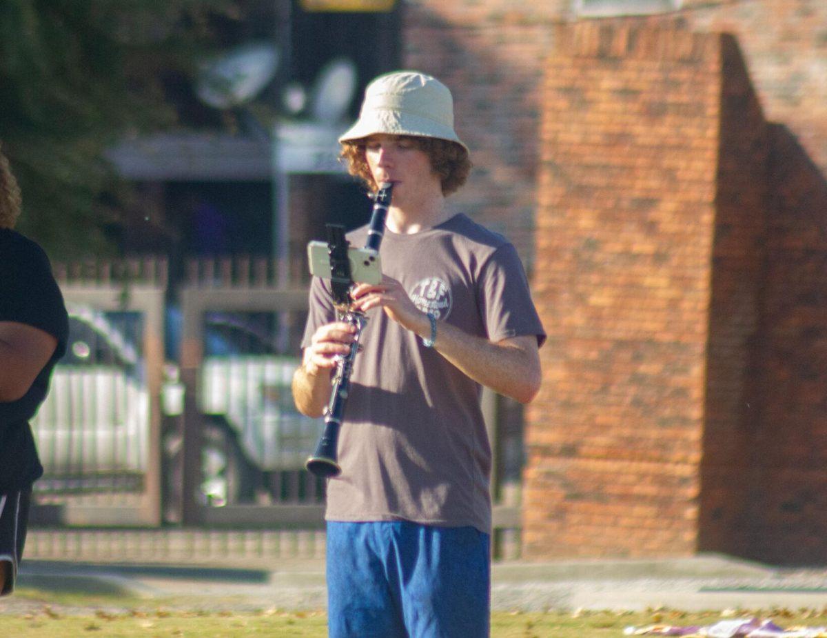 An LSU clarinet player reads music off of his phone on Thursday, Oct. 6, 2022, at the LSU Band Hall on Aster Street in Baton Rouge, La.