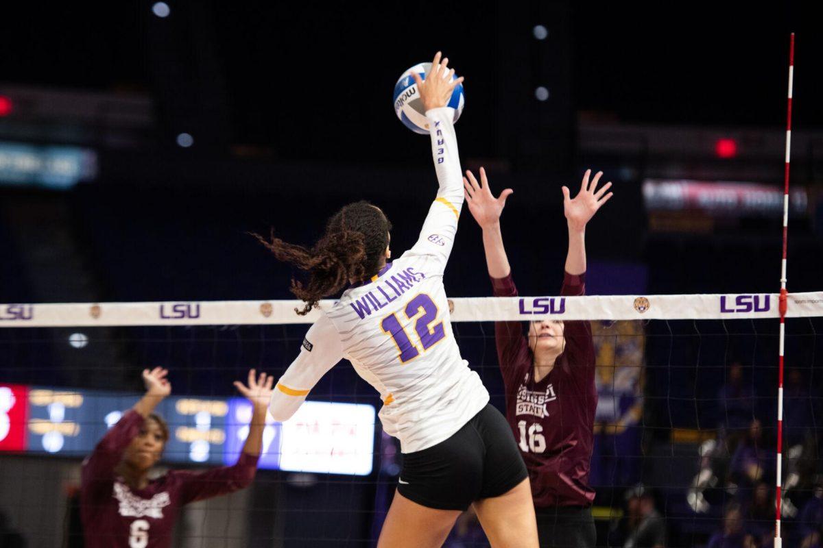 LSU volleyball junior middle blocker Alia Williams (12) hits the ball over the net on Saturday, Oct. 29, 2022, during LSU&#8217;s 3-2 victory against Mississippi State at the Pete Maravich Assembly Center in Baton Rouge, La.