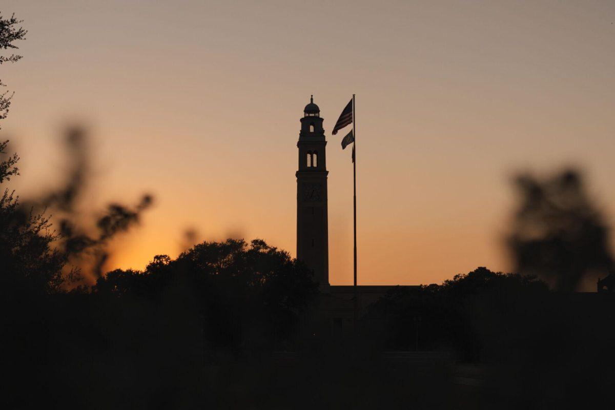 The Sun sets on Saturday, Oct. 8, 2022, behind Memorial Tower on LSU's campus in Baton Rouge, La.