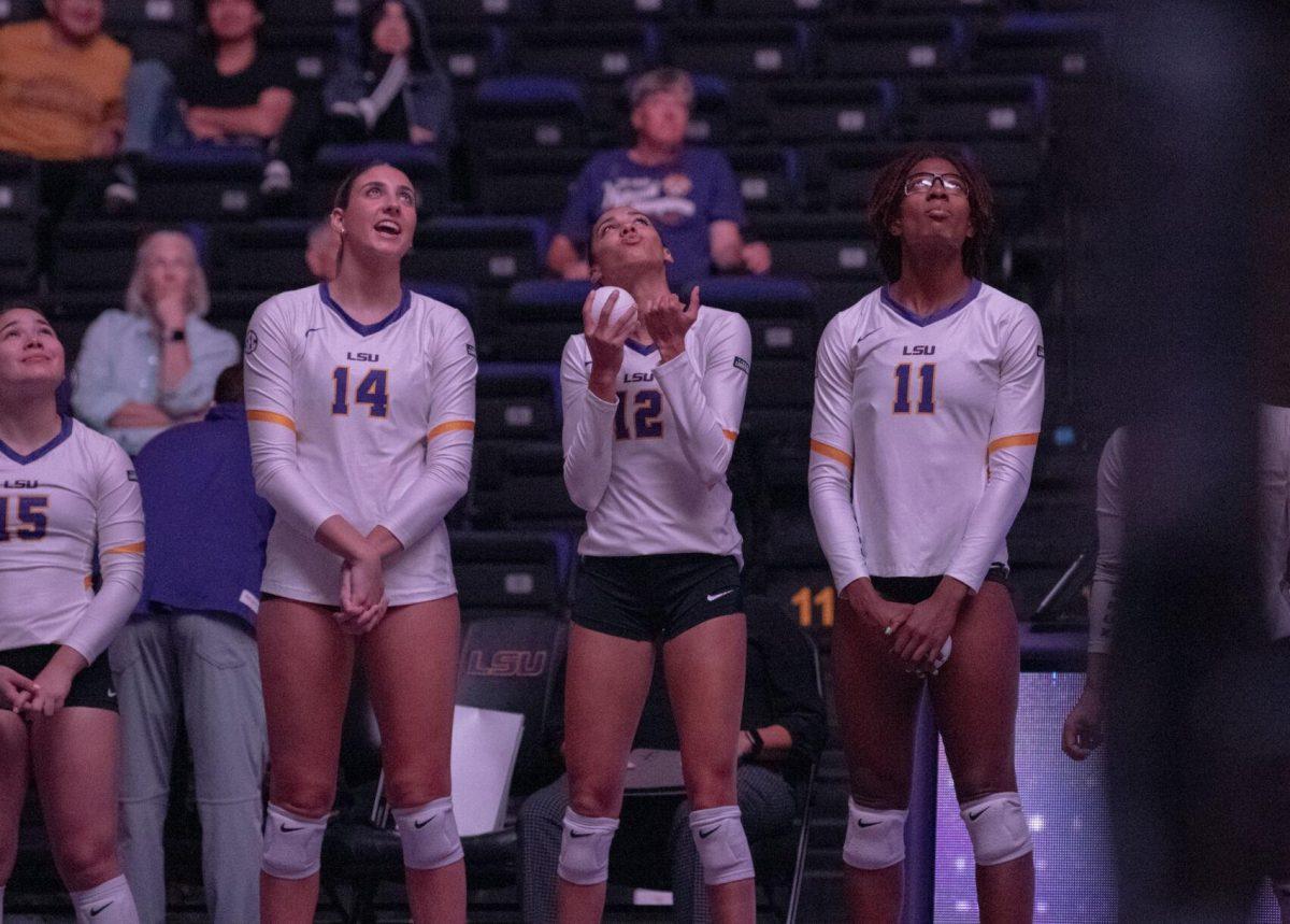 LSU volleyball senior middle blocker Allee Morris (14), LSU volleyball junior middle blocker Alia Williams (12), and LSU senior middle blocker Anita Anwusi (11) watch the jumbotron on Wednesday, Oct. 5, 2022, before their 3-2 victory over Auburn in the Pete Maravich Assembly Center on N. Stadium Drive.