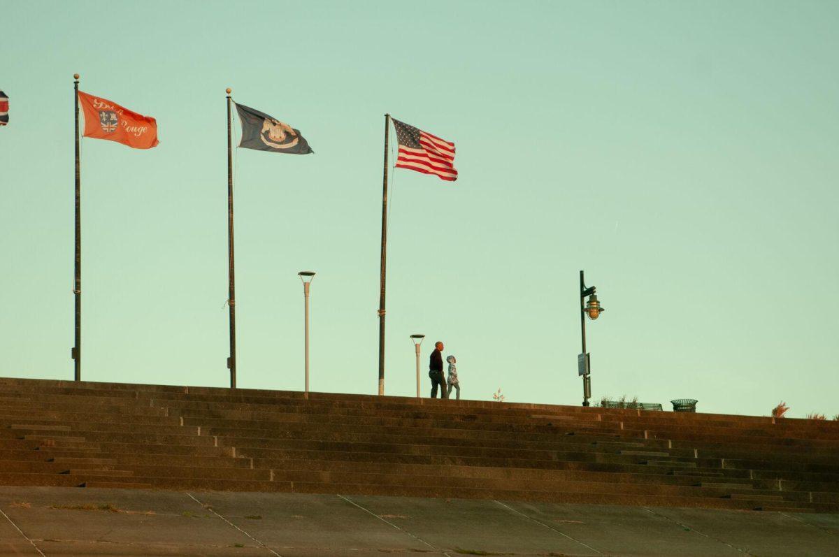 A father and daughter walk down the walkway near the Mississippi River on Thursday, Oct. 20, 2022, near River Road in Baton Rouge, La.