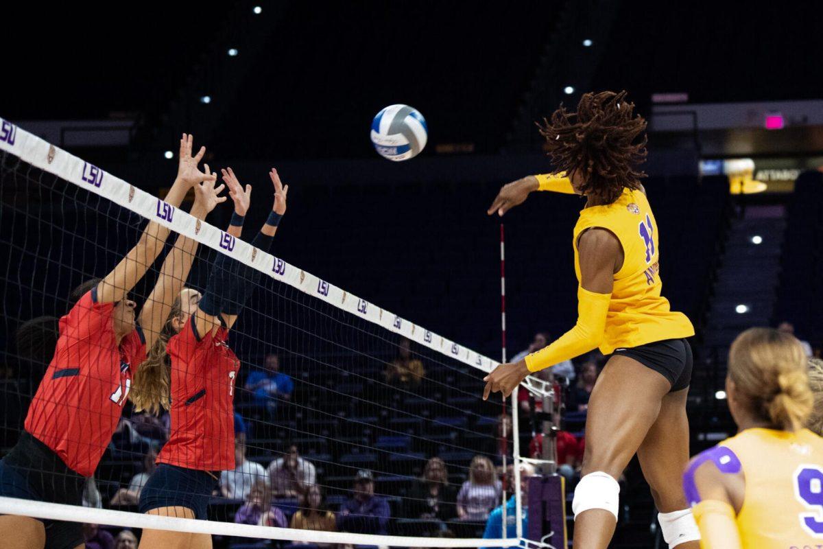 LSU volleyball senior middle blocker Anita Anwusi (11) hits the ball over the net on Saturday, Oct. 1, 2022, during LSU&#8217;s 2-3 defeat to Ole Miss at the Pete Maravich Assembly Center in Baton Rouge, La.