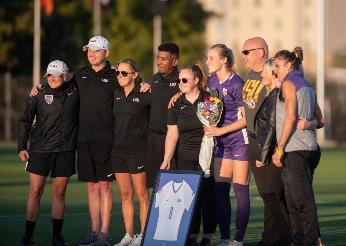 LSU soccer fifth-year senior defender Shannon Cooke (8) smiles with her coaches and family on senior night on Thursday, Oct. 27, 2022, before the start of LSU&#8217;s 4-1 victory against Ole Miss at LSU&#8217;s Soccer Stadium off of Nicholson Drive.