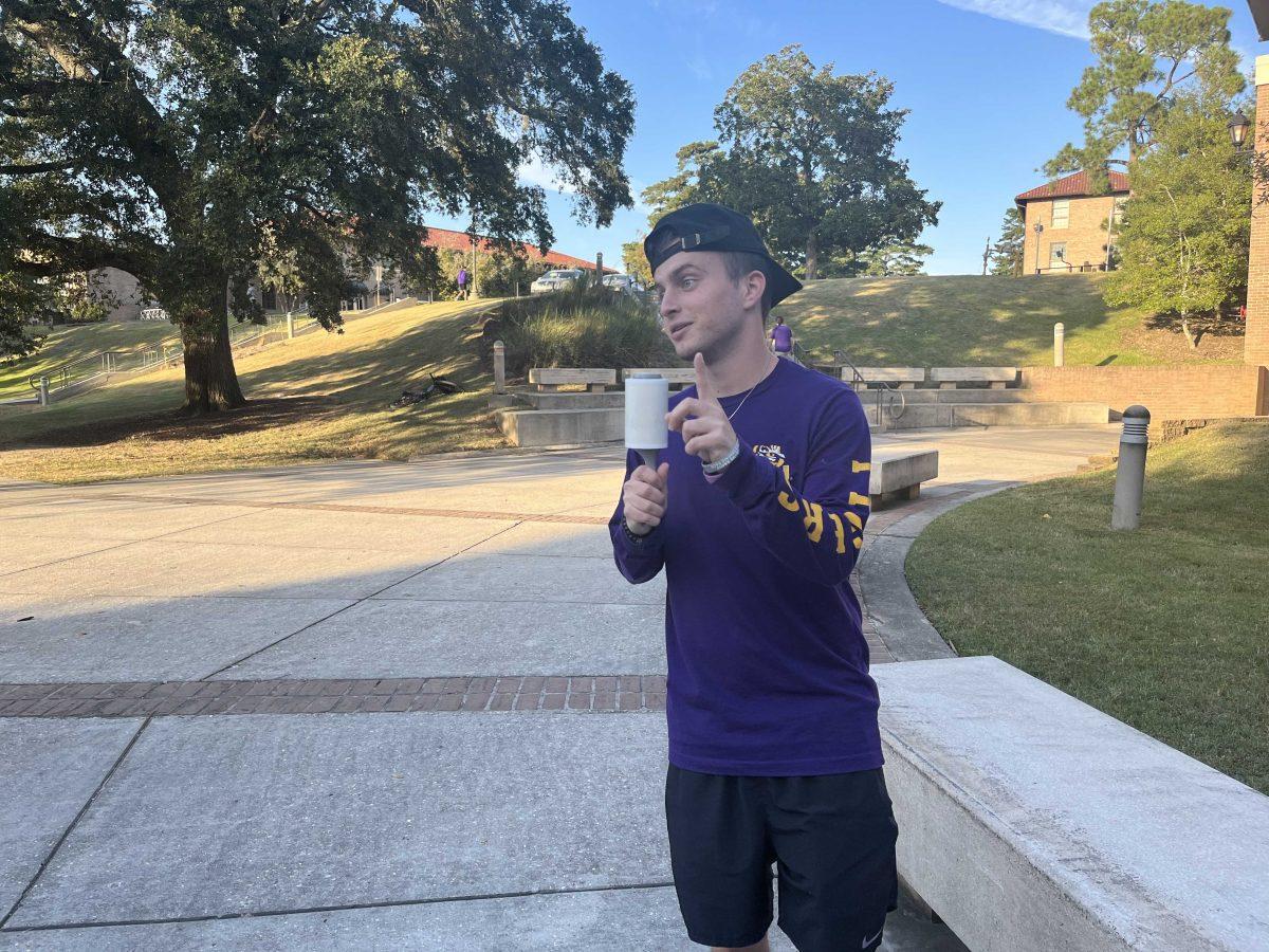 Christian Gladney poses with his lint roller microphone near North Hall on LSU's campus in Baton Rouge, La.