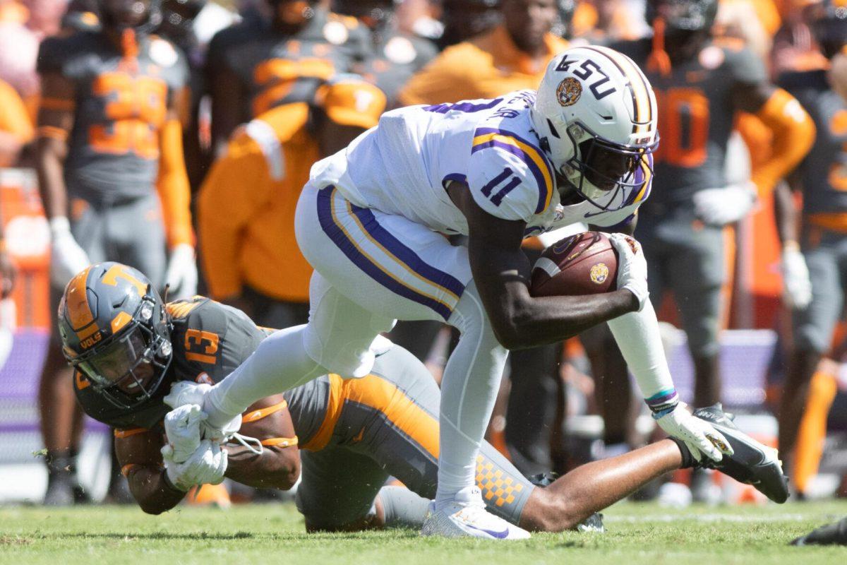 LSU sophomore wide receiver Brian Thomas Jr. (11) attempts to avoid a tackle on Saturday, Oct. 8, 2022, during LSU's defeat to Tennessee 13-40 in Tiger Stadium.