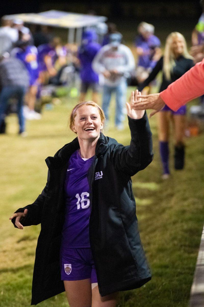 LSU soccer fifth-year senior defender Lindsi Jennings (16) gives a high five to a fan on Thursday, Oct. 27, 2022, after LSU&#8217;s 4-1 victory against Ole Miss at LSU&#8217;s Soccer Stadium off of Nicholson Drive.