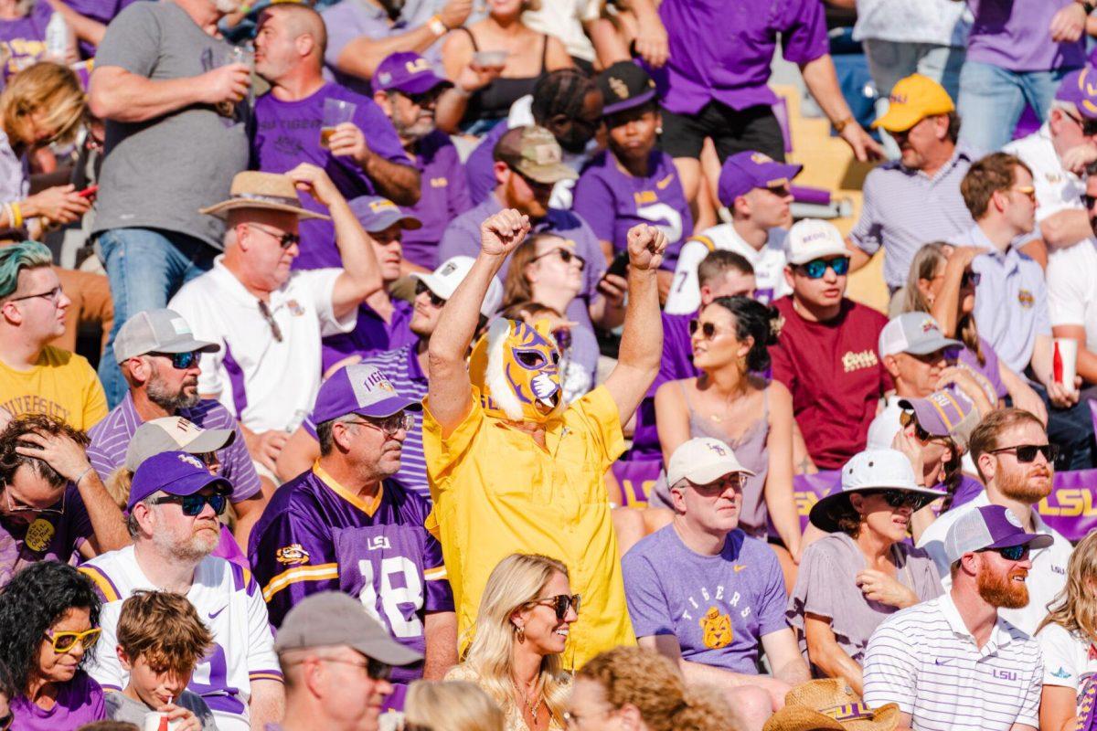 A fan dons a tiger mask on Saturday, Oct. 22, 2022, during LSU&#8217;s 45-20 victory over Ole Miss in Tiger Stadium in Baton Rouge, La.