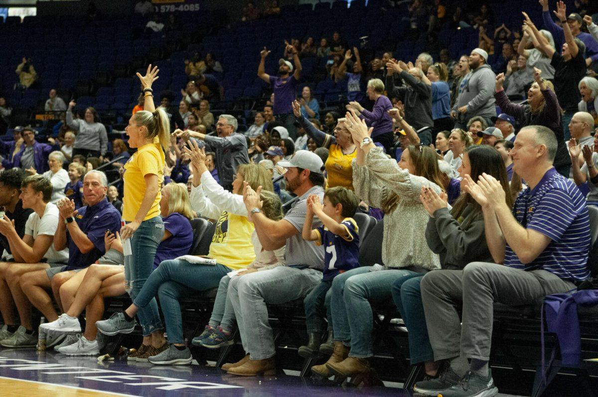 Court-side fans cheer after a goal is made at the LSU women's basketball exhibition game against Mississippi College on Thursday, Oct. 27, 2022, in the Pete Maravich Assembly Center on N. Stadium Drive.