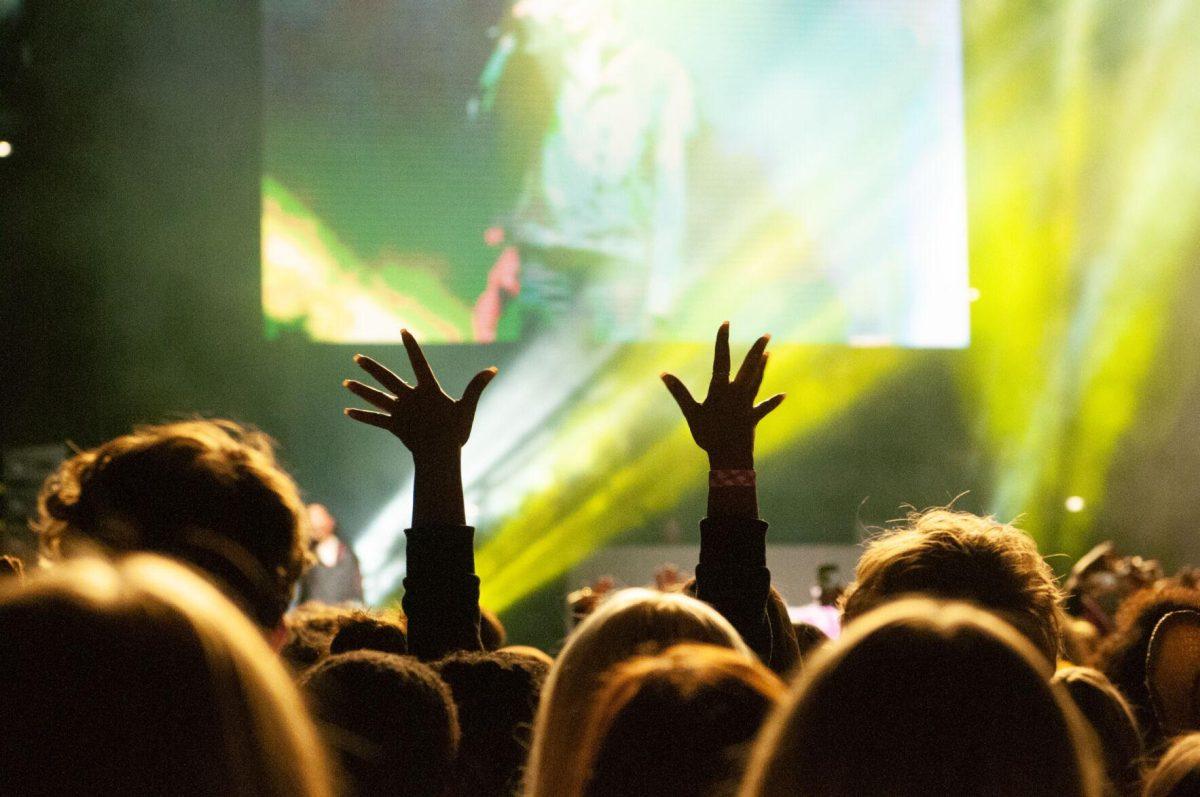 A student in the crowd reaches her hands to the sky on Wednesday, Oct. 19, 2022, at LSU's homecoming concert at the PMAC on North Stadium Drive in Baton Rouge, La.