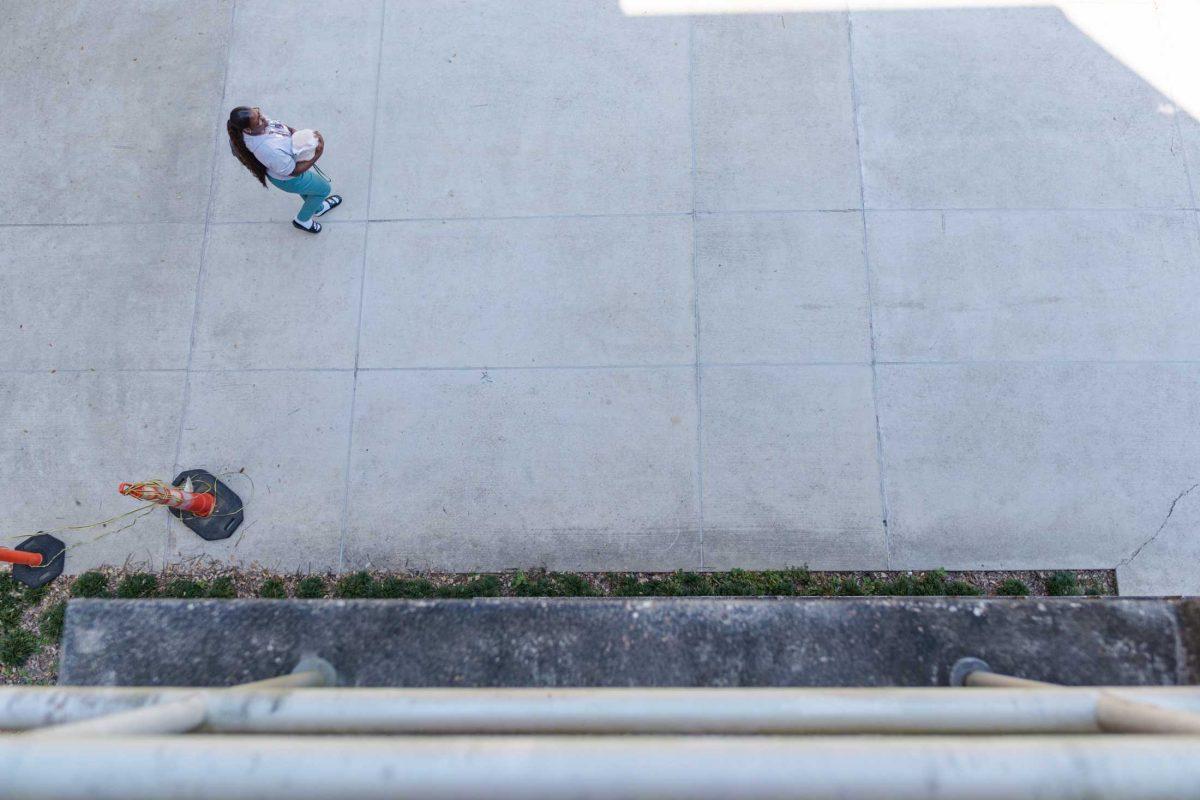 An LSU student carries take-away containers on Friday, Oct. 7, 2022 near the Art and Design building in Baton Rouge, La.