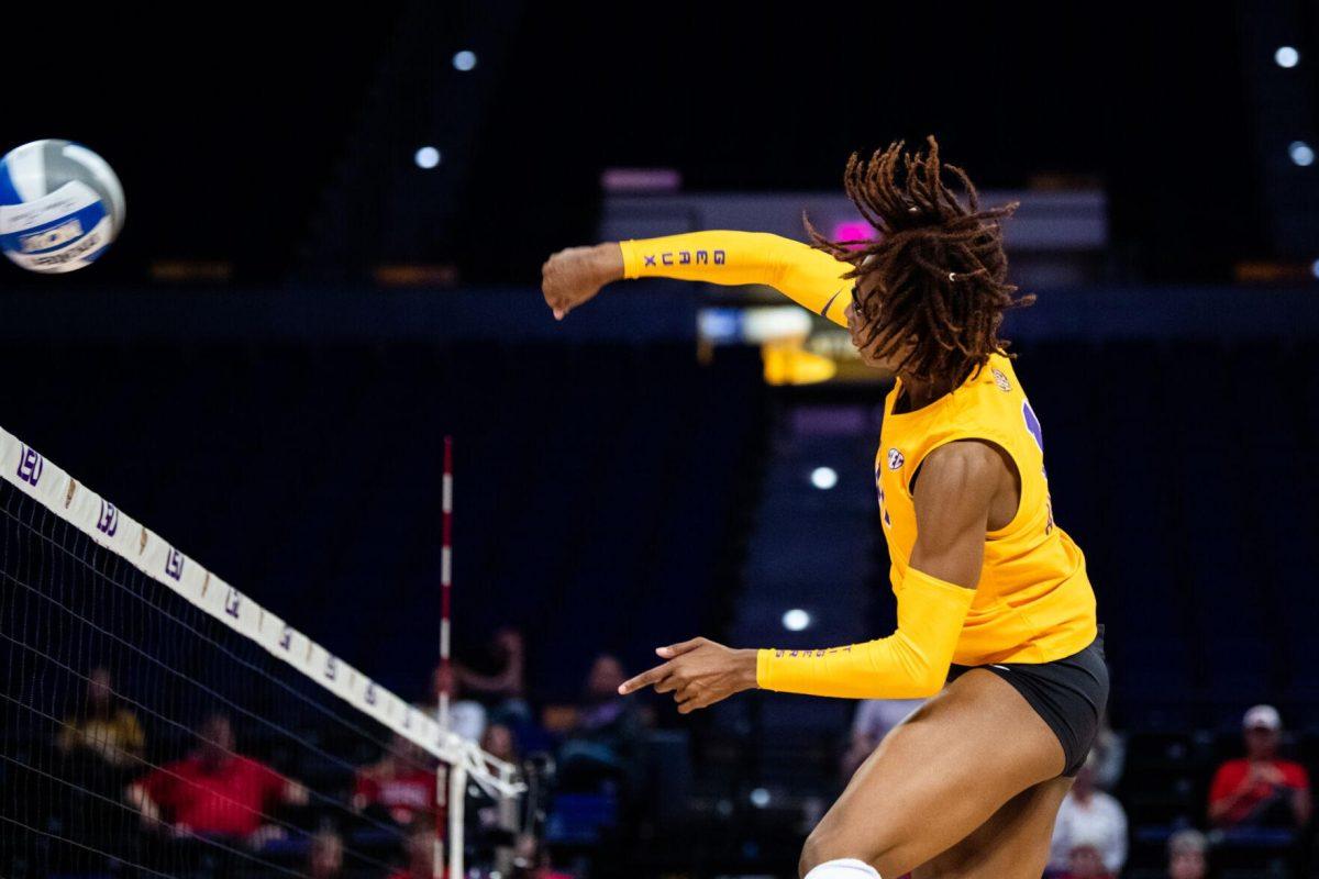 LSU volleyball senior middle blocker Anita Anwusi (11) hits the ball over the net on Saturday, Oct. 1, 2022, during LSU&#8217;s 2-3 defeat to Ole Miss at the Pete Maravich Assembly Center in Baton Rouge, La.