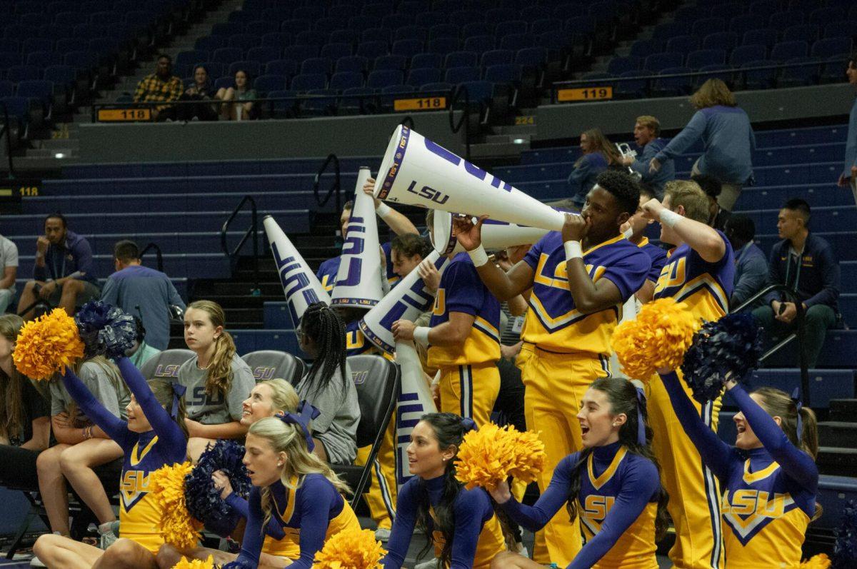 LSU cheerleaders make a starfish out of megaphones and roar with the crowd to distract a Mississippi College player during her free throw at the LSU women's basketball exhibition game on Thursday, Oct. 27, 2022, in the Pete Maravich Assembly Center on N. Stadium Drive.