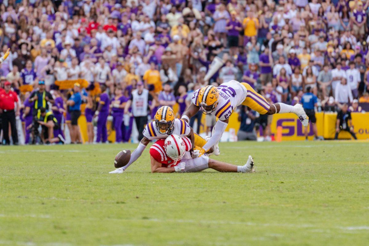 LSU football senior safety Jay Ward (5) and fifth-year senior linebacker Micah Baskerville go for the tackle on Saturday, Oct. 22, 2022, during LSU&#8217;s 45-20 victory over Ole Miss in Tiger Stadium in Baton Rouge, La.