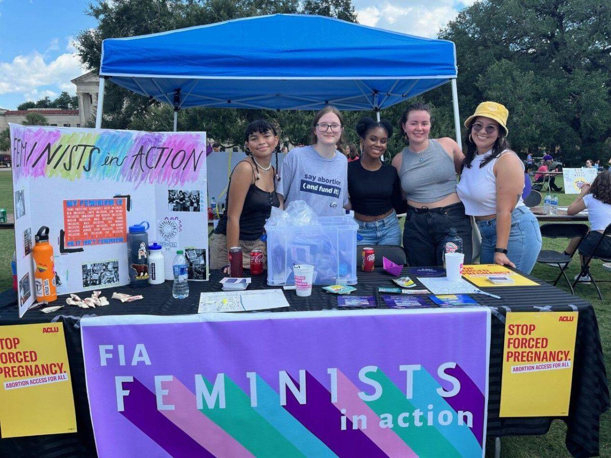 Feminists in Action officers stand at their table during Fall Fest in the LSU Parade Grounds on Sept. 16 in Baton Rouge, La.