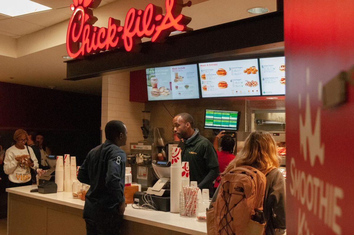 A Chick-fil-A employee takes an order on Thursday, Oct. 6, 2022, in the LSU Student Union on Highland Road in Baton Rouge, La.