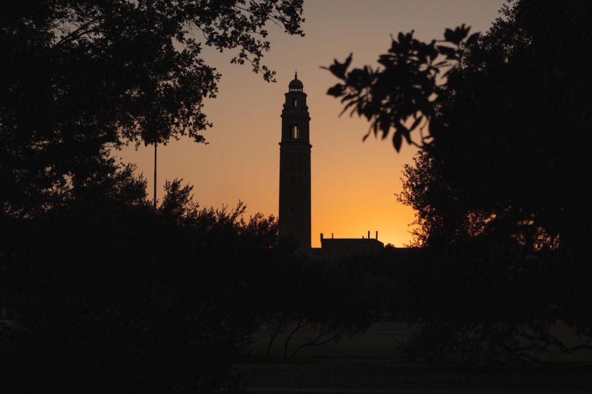 The Sun sets on Saturday, Oct. 8, 2022, behind Memorial Tower on LSU's campus in Baton Rouge, La.