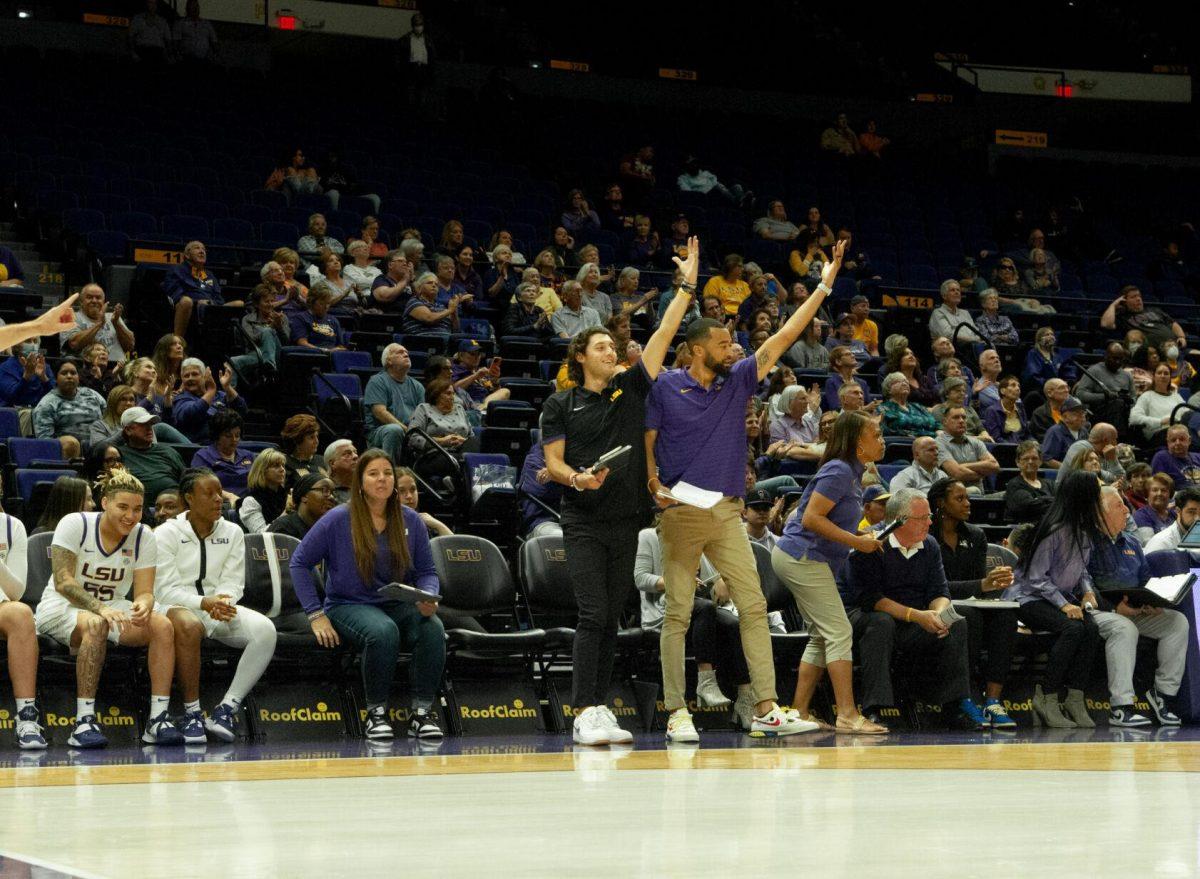 Assistant director for operations Joe Schwartz (left) and assistant coach Gary Redus II (right) stand and cheer after a made goal at the LSU women's basketball exhibition game against Mississippi College on Thursday, Oct. 27, 2022, in the Pete Maravich Assembly Center on N. Stadium Drive.