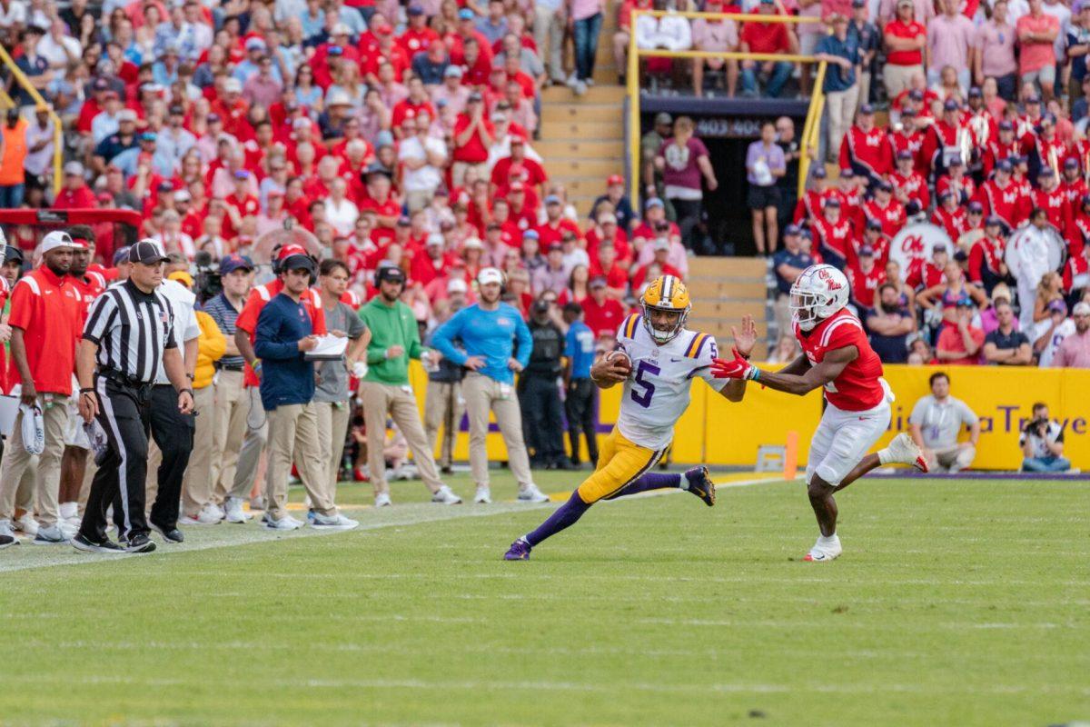 LSU football junior quarterback Jayden Daniels (5) runs down the field on Saturday, Oct. 22, 2022, during LSU&#8217;s 45-20 victory over Ole Miss in Tiger Stadium in Baton Rouge, La.